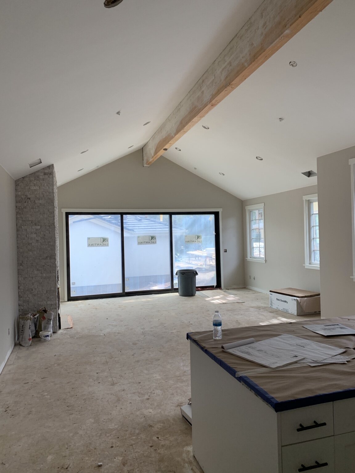 Interior room with finished window trim and exposed ceiling beam