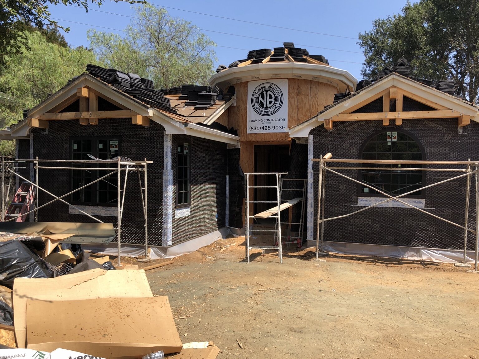 One of two side-by-side Los Altos custom homes under construction with Noland Builders signage