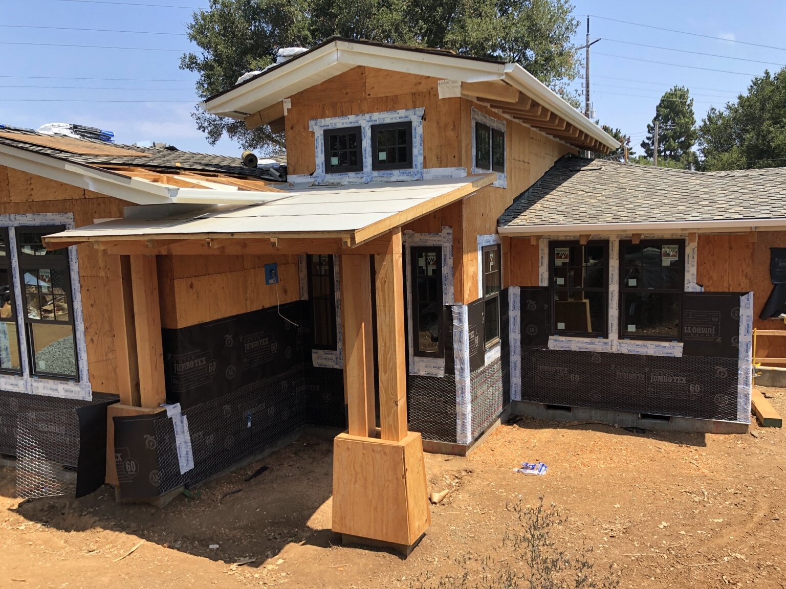 Front elevation of the neighboring Los Altos custom home during exterior construction