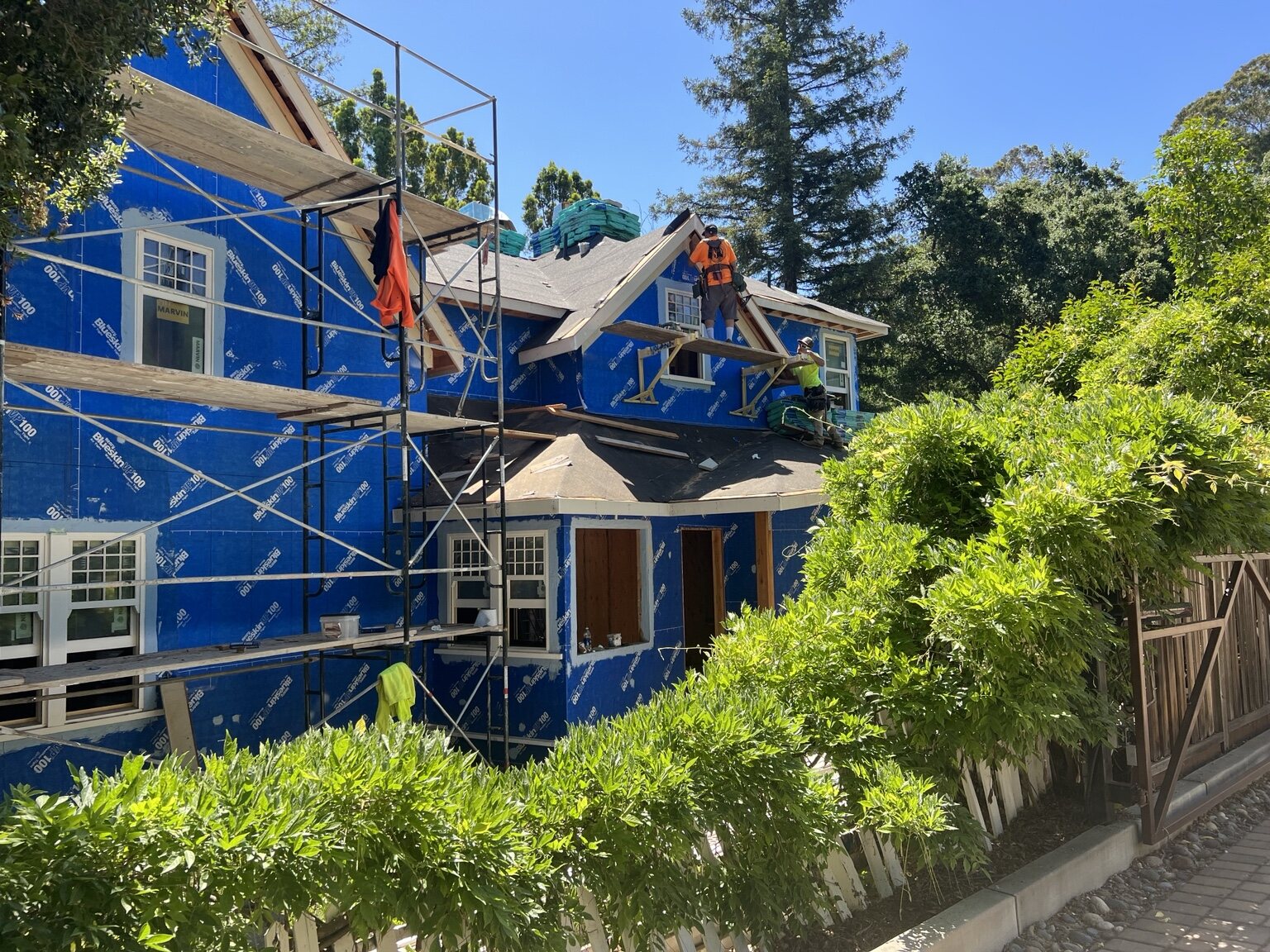 Crew completing elevated exterior and roofing work on the historic residence