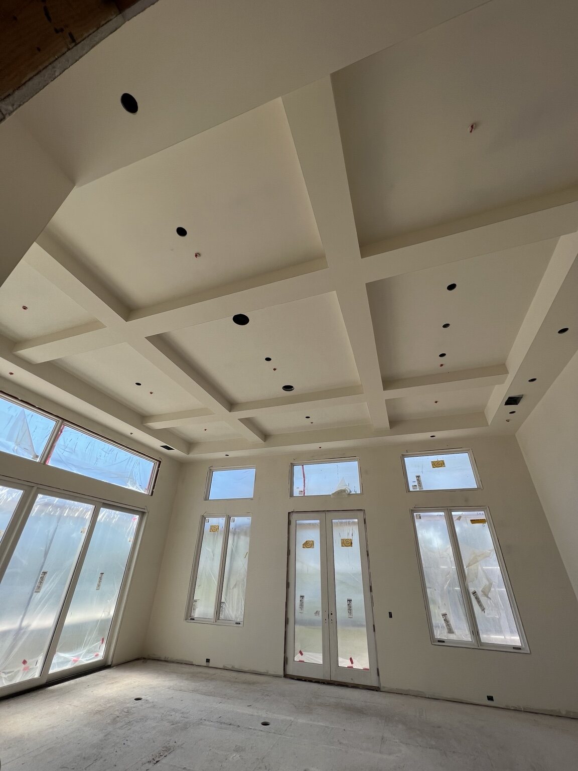Detailed coffered ceiling and new window openings during interior finishing