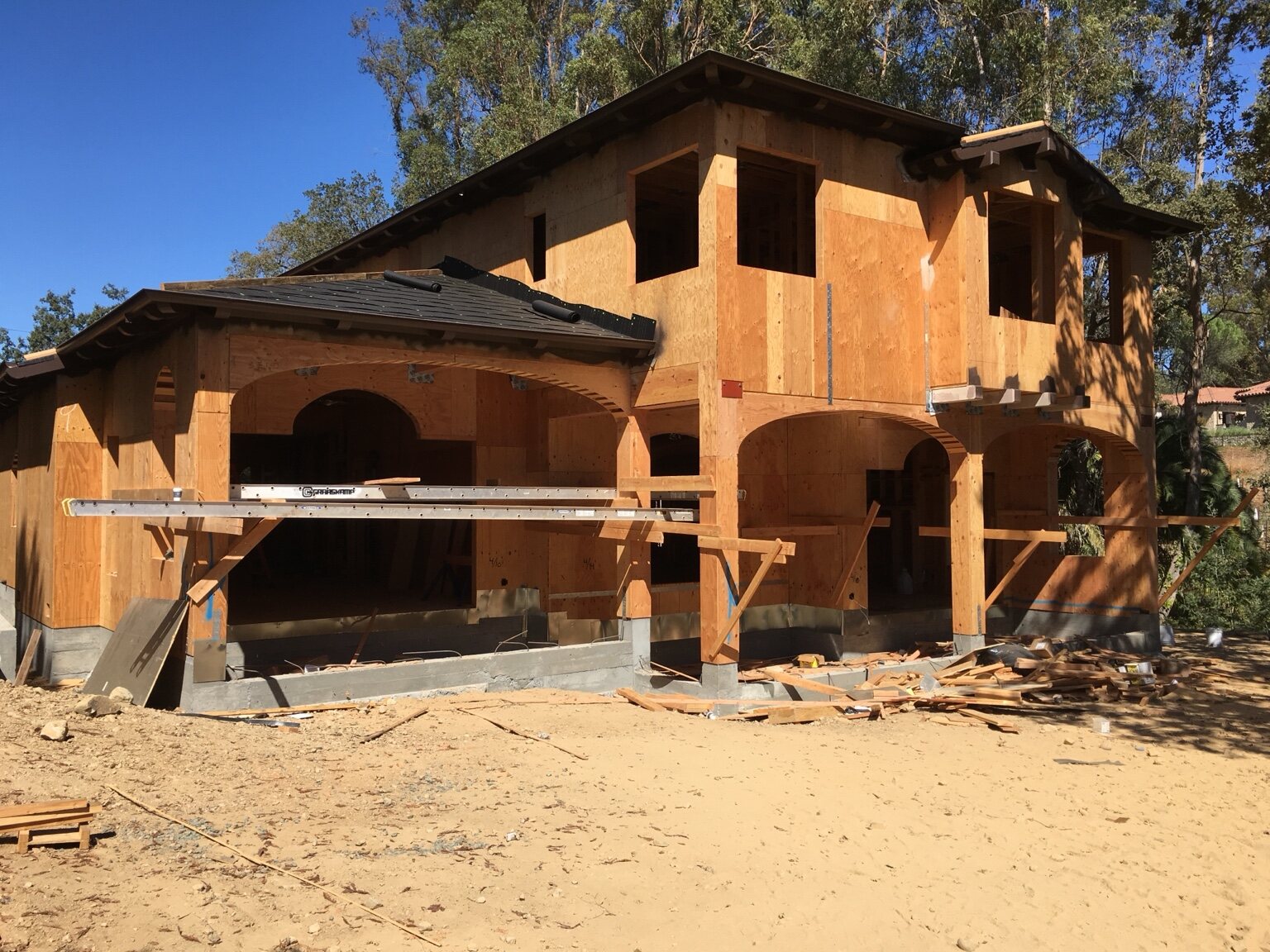 Rear elevation framing with deep overhangs and arched openings