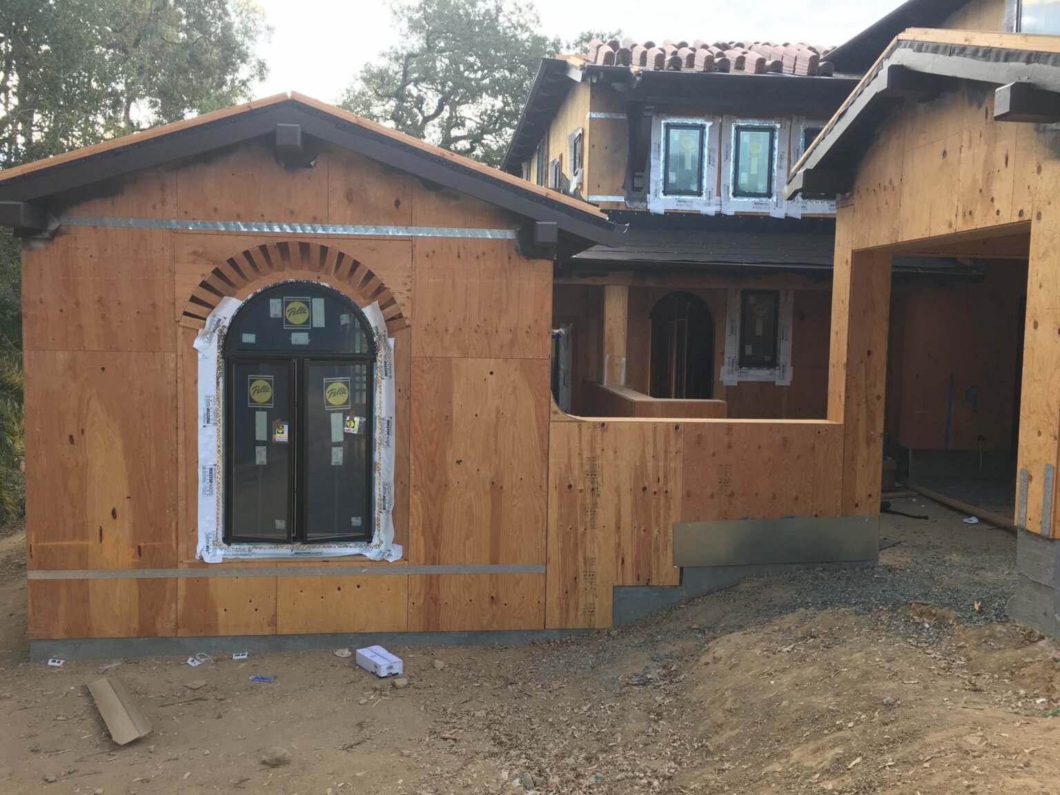 Installed arched window and surrounding custom framing