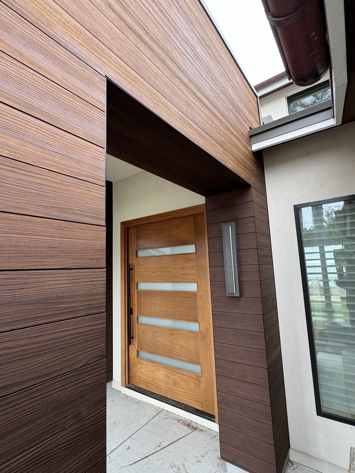Close-up of custom exterior wood cladding and entry detailing