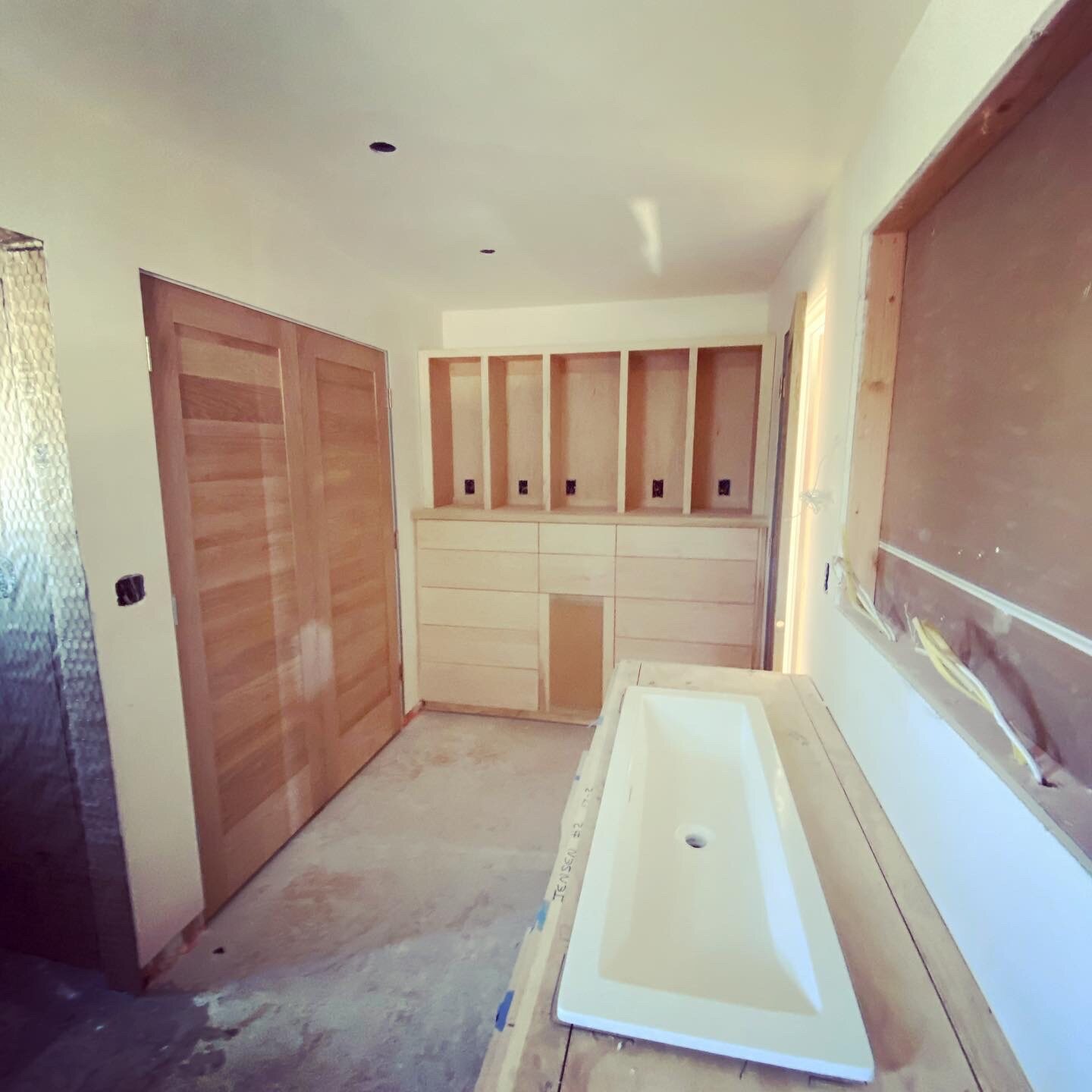 Custom bathroom vanity and wall casework during installation