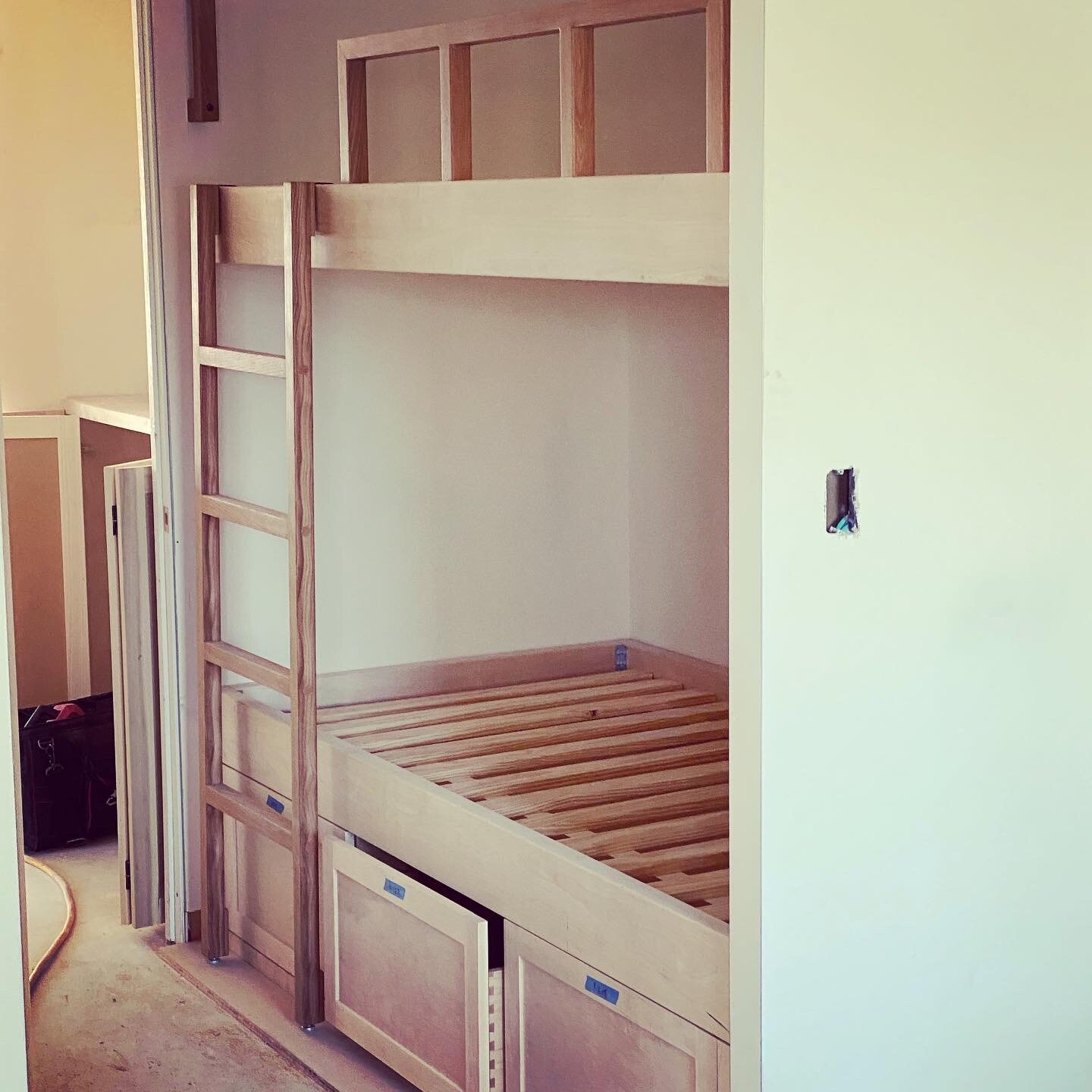 Custom built-in bunk bed with integrated drawers and ladder